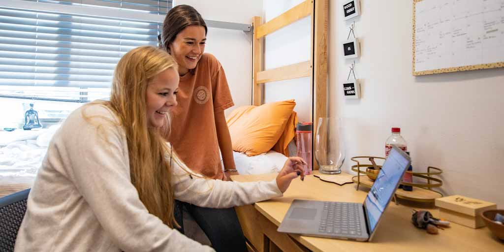 Students in DSU dorm room reviewing homework